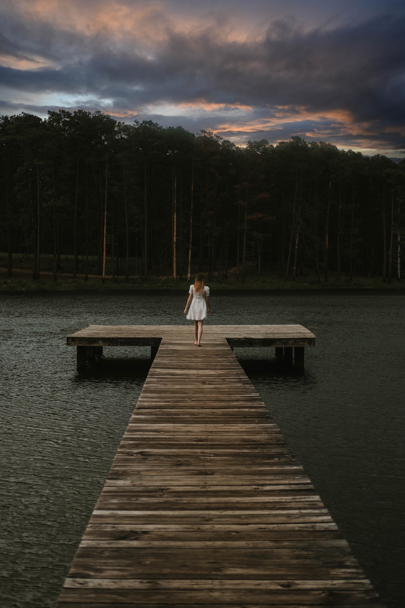 Girl standing on dock in moody Louisiana landscape photography